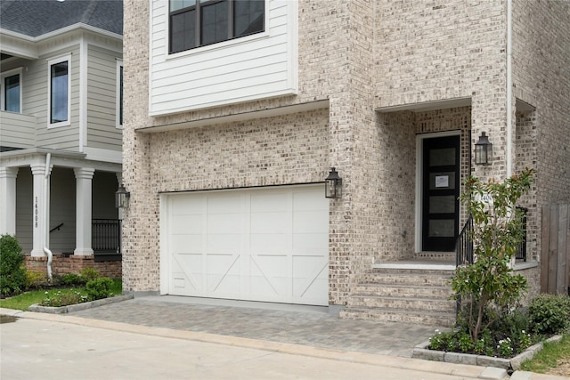 property entrance with covered porch and a garage