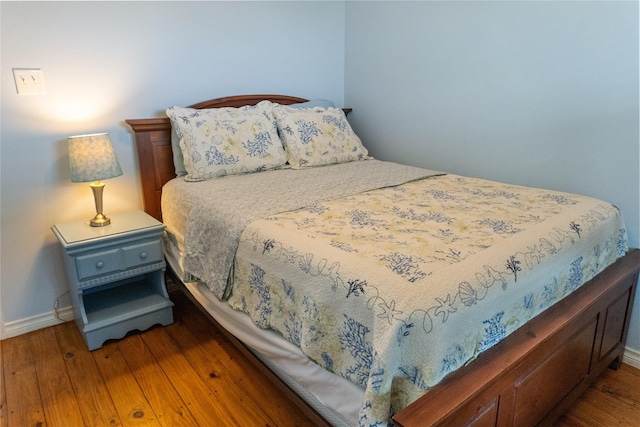 bedroom with dark hardwood / wood-style floors