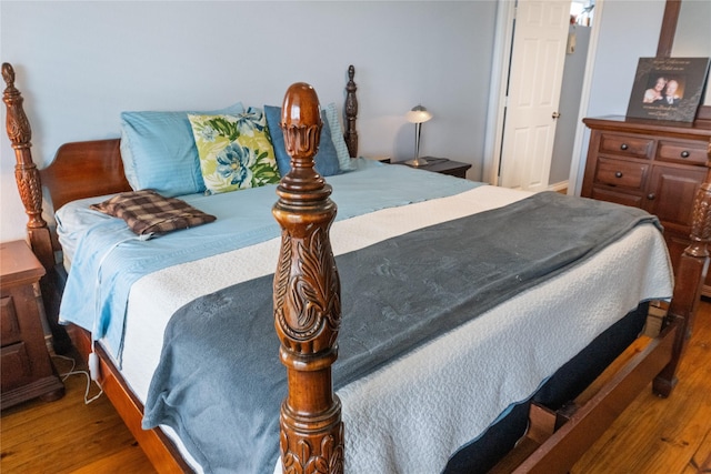 bedroom with dark wood-type flooring