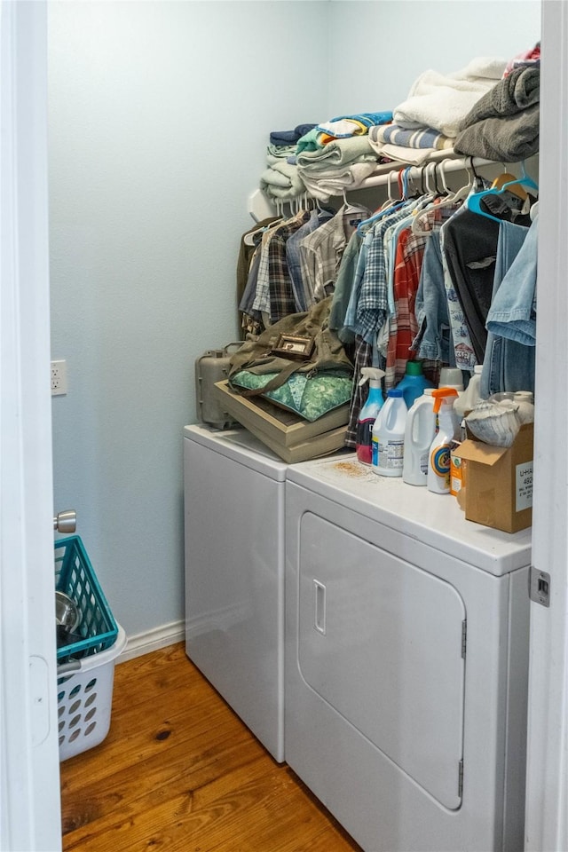 washroom featuring wood-type flooring and separate washer and dryer