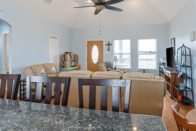 living room with hardwood / wood-style floors, ceiling fan, and lofted ceiling