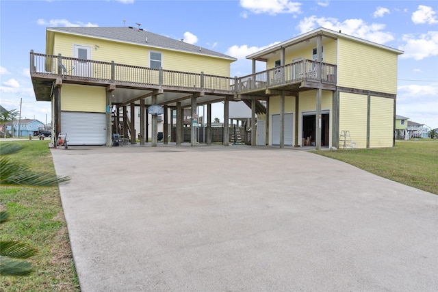 rear view of property featuring a yard, a garage, and a carport