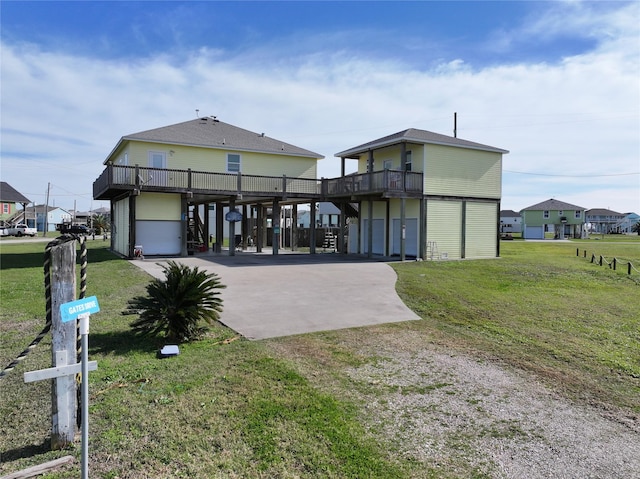 view of front facade with a front yard, a garage, and a carport