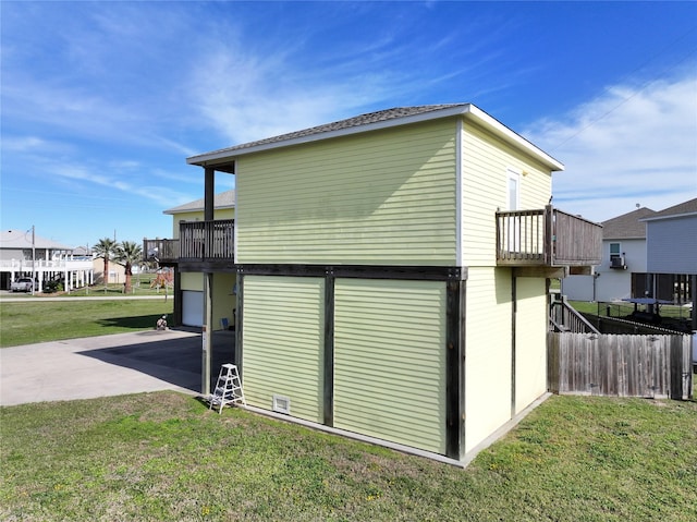 exterior space featuring a balcony and a yard