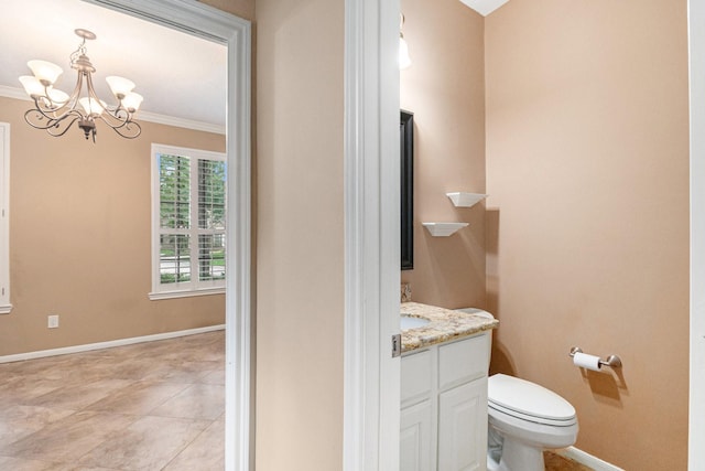 bathroom with vanity, toilet, crown molding, and an inviting chandelier