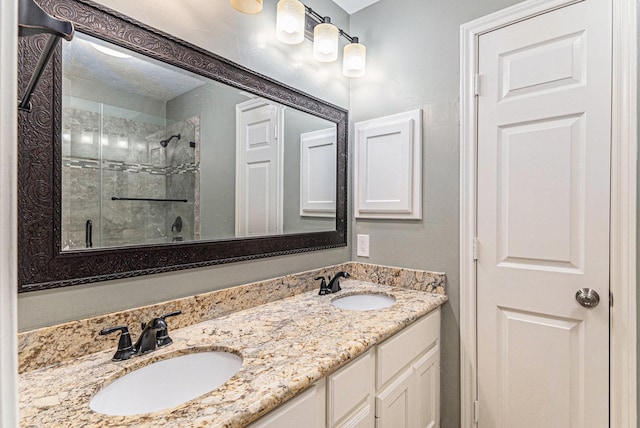 bathroom featuring a tile shower and vanity