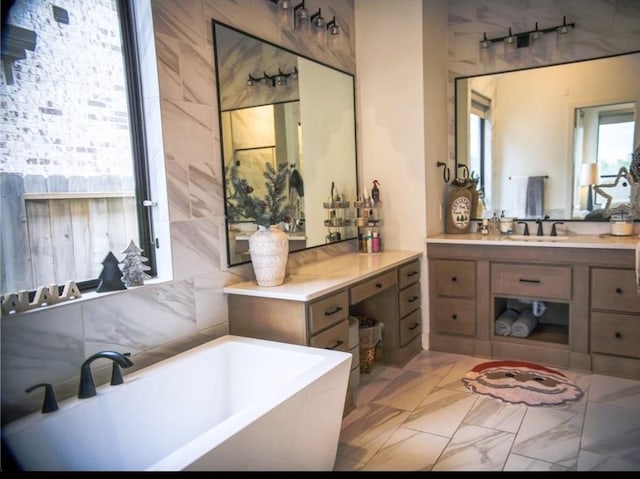 bathroom featuring vanity and a tub