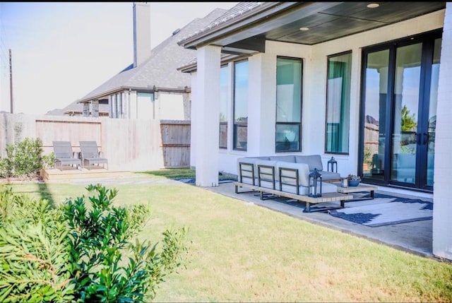 back of property with an outdoor living space, a yard, and a patio