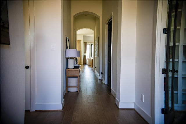 hall with dark wood-type flooring