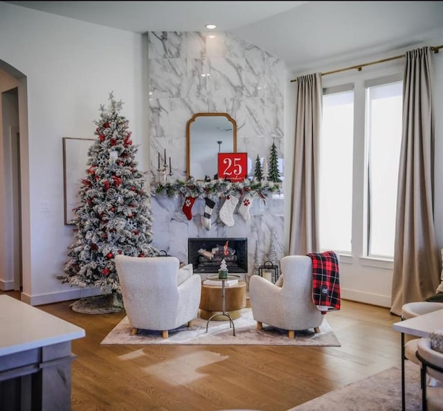 sitting room featuring hardwood / wood-style floors and a high end fireplace