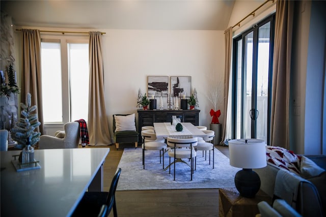 dining space with hardwood / wood-style floors and lofted ceiling