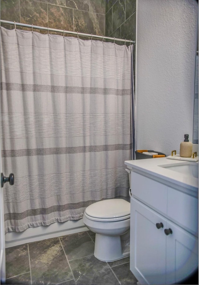 full bathroom featuring vanity, shower / bath combination with curtain, and toilet