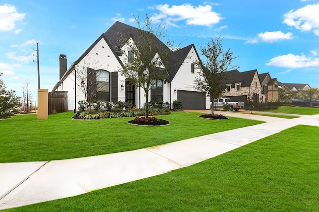 view of front of house with a garage and a front yard