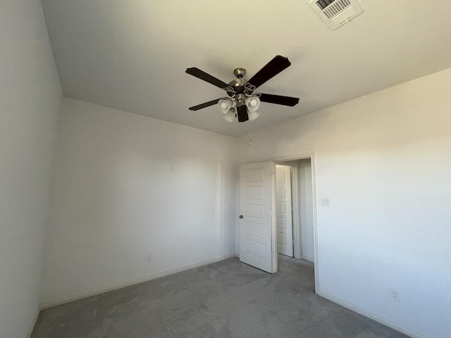 carpeted spare room featuring ceiling fan