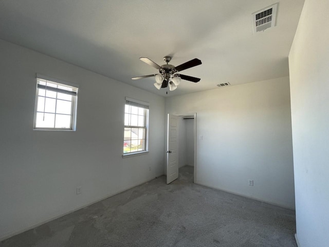 carpeted empty room with ceiling fan