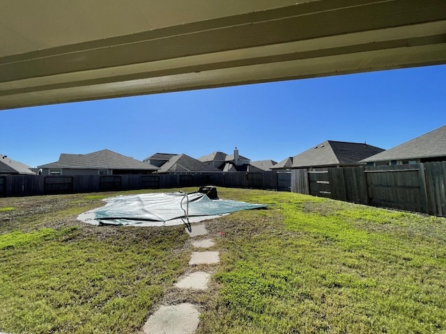 view of yard with a covered pool