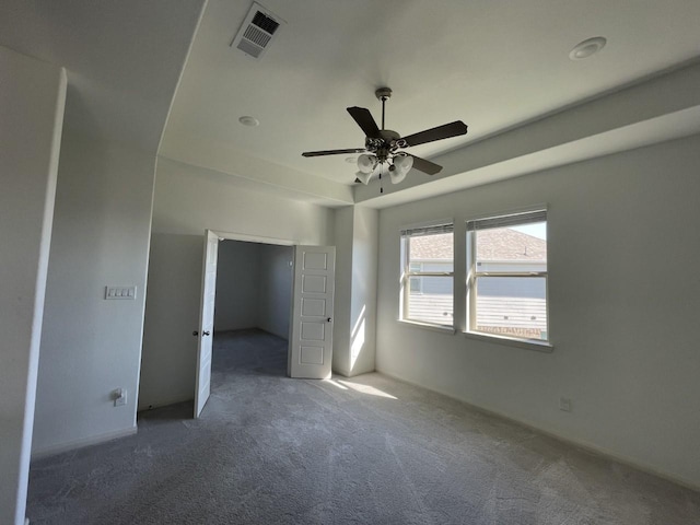 interior space featuring dark carpet and ceiling fan