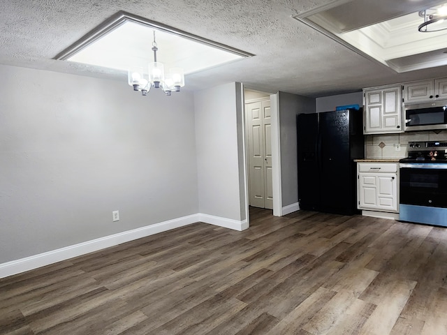 kitchen with white cabinetry, backsplash, stainless steel appliances, and a textured ceiling