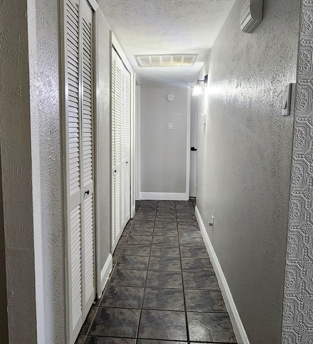 hallway with a textured ceiling