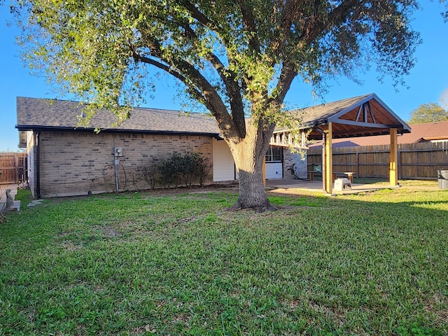 back of house with a patio area and a lawn