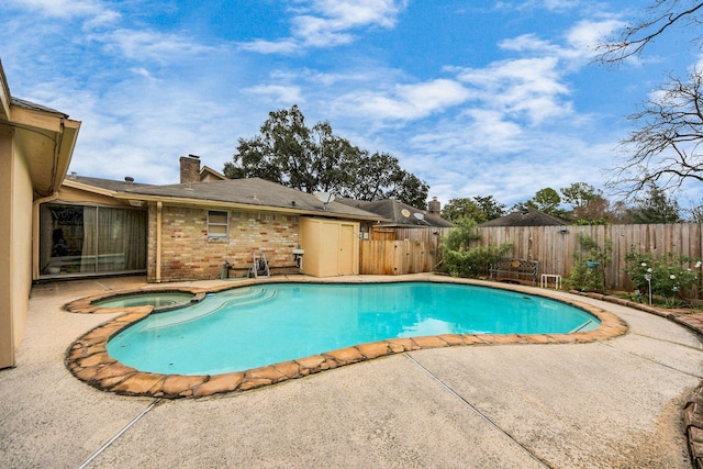 view of swimming pool featuring an in ground hot tub and a patio