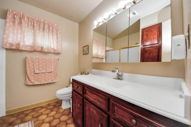 bathroom featuring tile patterned floors, vanity, and toilet