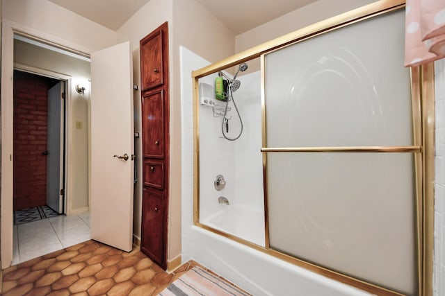 bathroom with tile patterned flooring and shower / bath combination with glass door