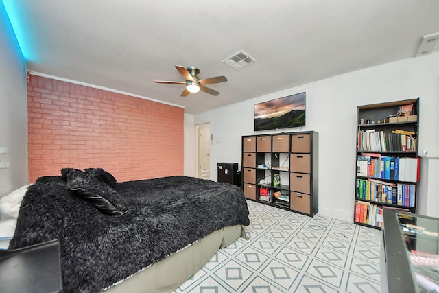 bedroom with ceiling fan and brick wall