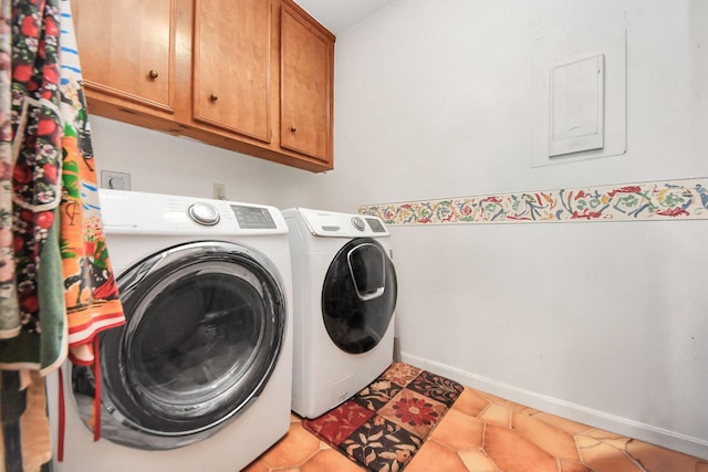 laundry room featuring washing machine and clothes dryer, light tile patterned floors, and cabinets