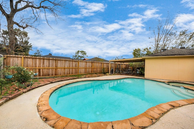 view of pool with an in ground hot tub