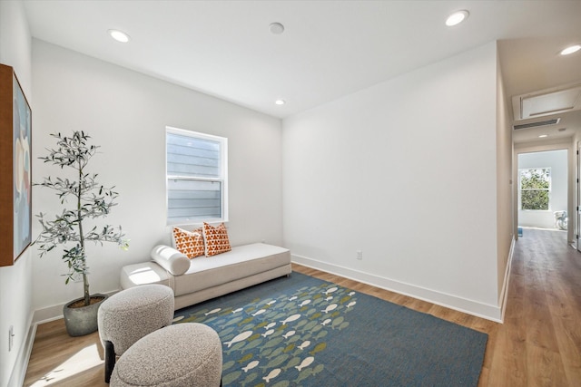 living area with hardwood / wood-style floors