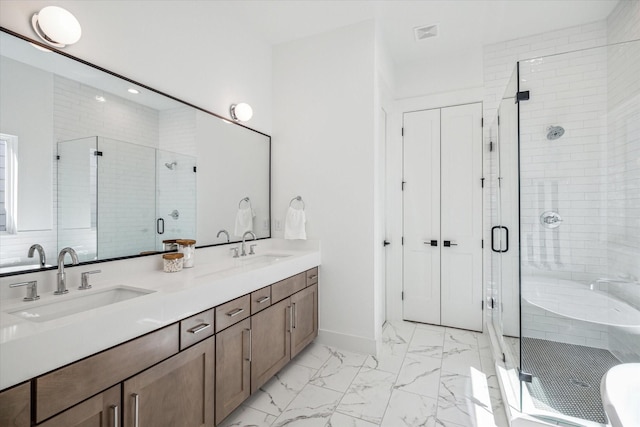 bathroom with shower with separate bathtub and vanity