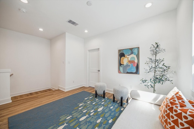 living area with hardwood / wood-style flooring