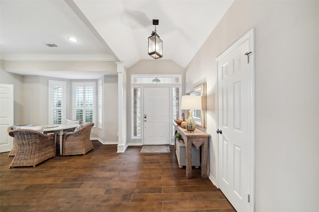 entryway with crown molding and vaulted ceiling