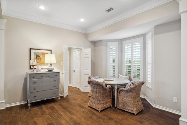 dining space with crown molding and dark hardwood / wood-style flooring