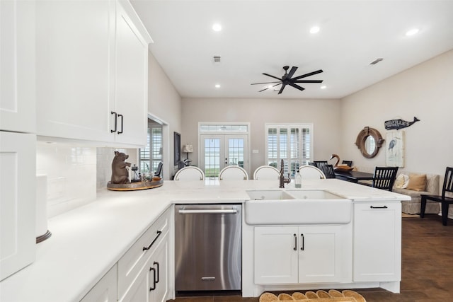 kitchen featuring sink, dark hardwood / wood-style flooring, stainless steel dishwasher, kitchen peninsula, and white cabinets