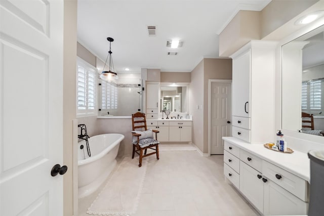 bathroom with tile patterned flooring, vanity, crown molding, and plus walk in shower