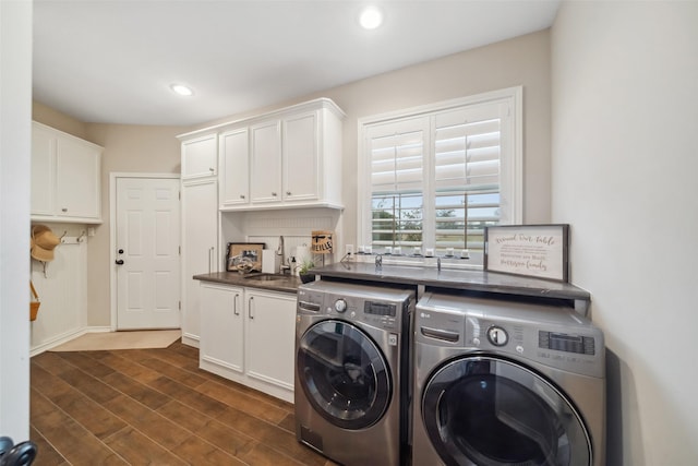 washroom with washer and clothes dryer, cabinets, and sink