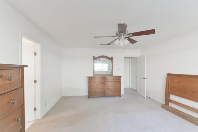 unfurnished bedroom featuring ceiling fan and light carpet