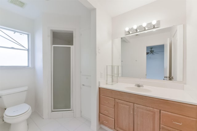 bathroom with ceiling fan, vanity, an enclosed shower, and toilet