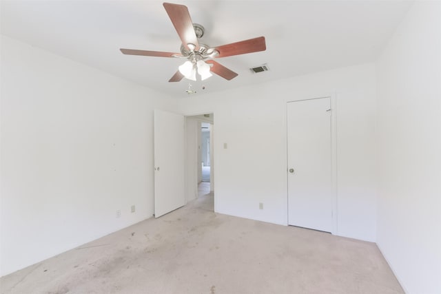 unfurnished bedroom with ceiling fan and light carpet