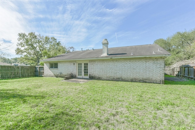 rear view of property with a yard and french doors