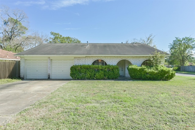 ranch-style house featuring a garage and a front lawn