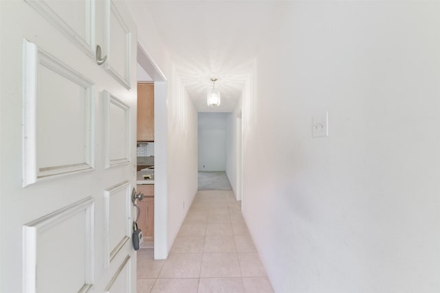 corridor featuring light tile patterned floors