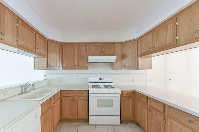 kitchen with decorative backsplash, sink, light tile patterned flooring, and white appliances