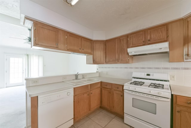 kitchen featuring white appliances, sink, ceiling fan, light tile patterned floors, and a textured ceiling