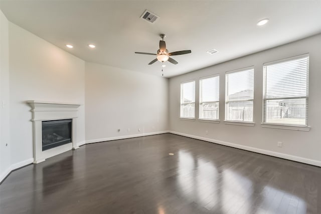 unfurnished living room featuring dark hardwood / wood-style floors and ceiling fan