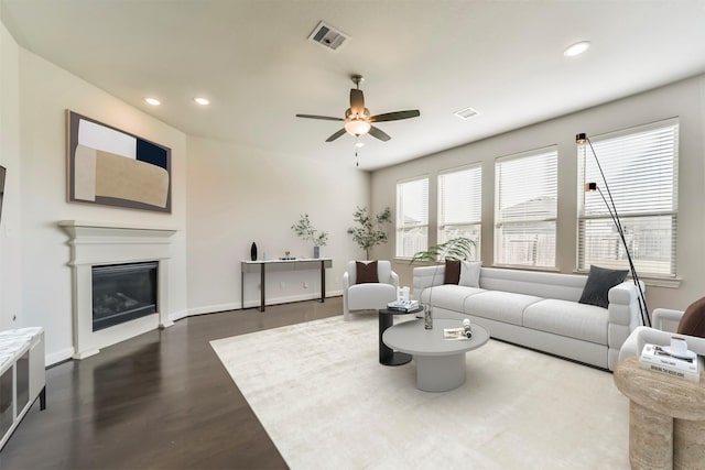 living room with dark hardwood / wood-style floors and ceiling fan