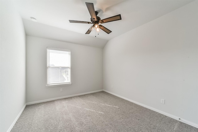 empty room with ceiling fan, carpet floors, and lofted ceiling