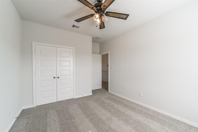 unfurnished bedroom with ceiling fan, a closet, and carpet floors